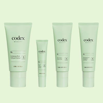 Codex Beauty Bia Discovery Set bottles on green background - from left to right these are Exfoliating Wash, Eye Gel Cream, Day Cream and Skin Superfood