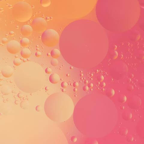 Oil droplets on pink and peach background