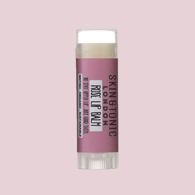 Skin & Tonic Rose Lip Balm tube on dusky pink background